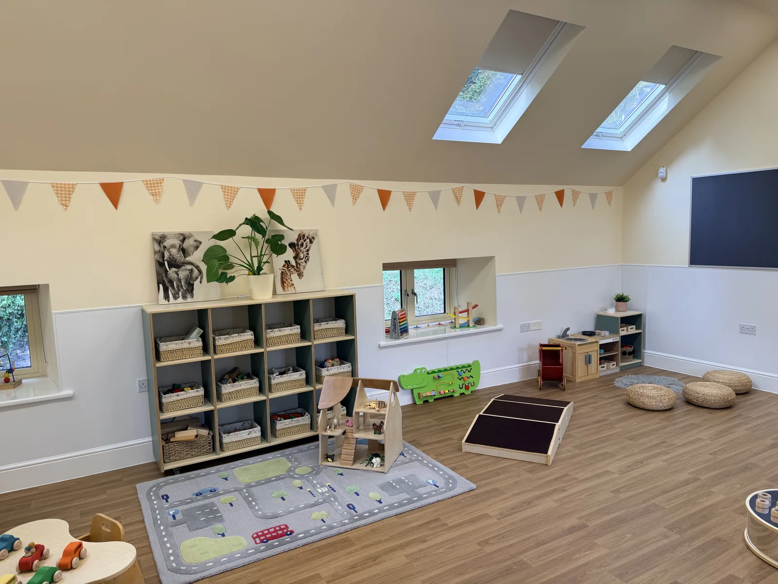 A bright playroom with skylights and bunting at Limpley Stoke