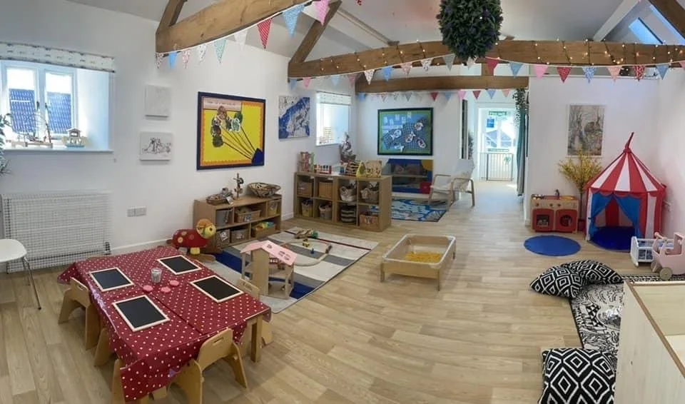 The Nest baby room at Buttercup Barn with wooden beams and play areas